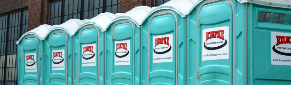 Row of portable restrooms outside an event