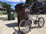 Bike Leaning Against Trash Cart