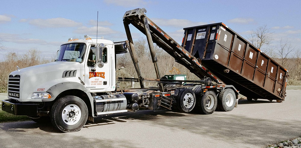 Rumpke hauling truck with large roll off dumpster