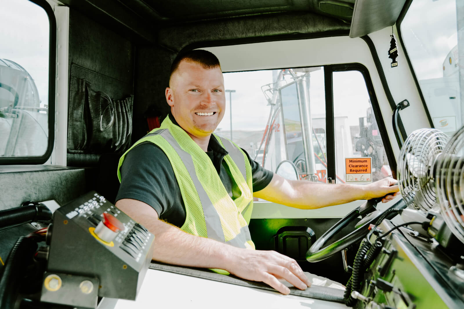 Rumpke Truck Driver Smiling In Driver Seat